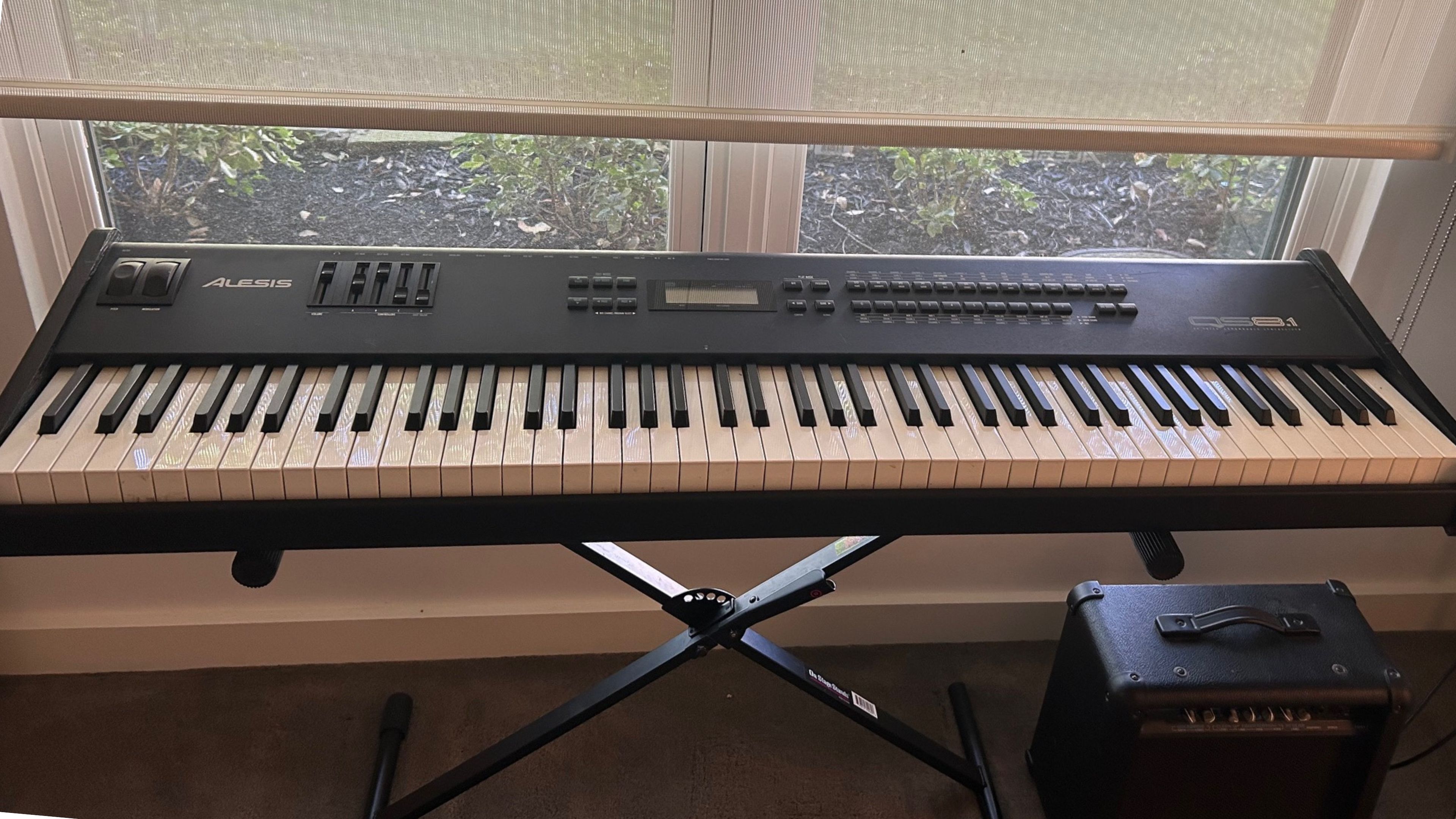Wood keyboard cover placed over a keyboard in a refined studio setting